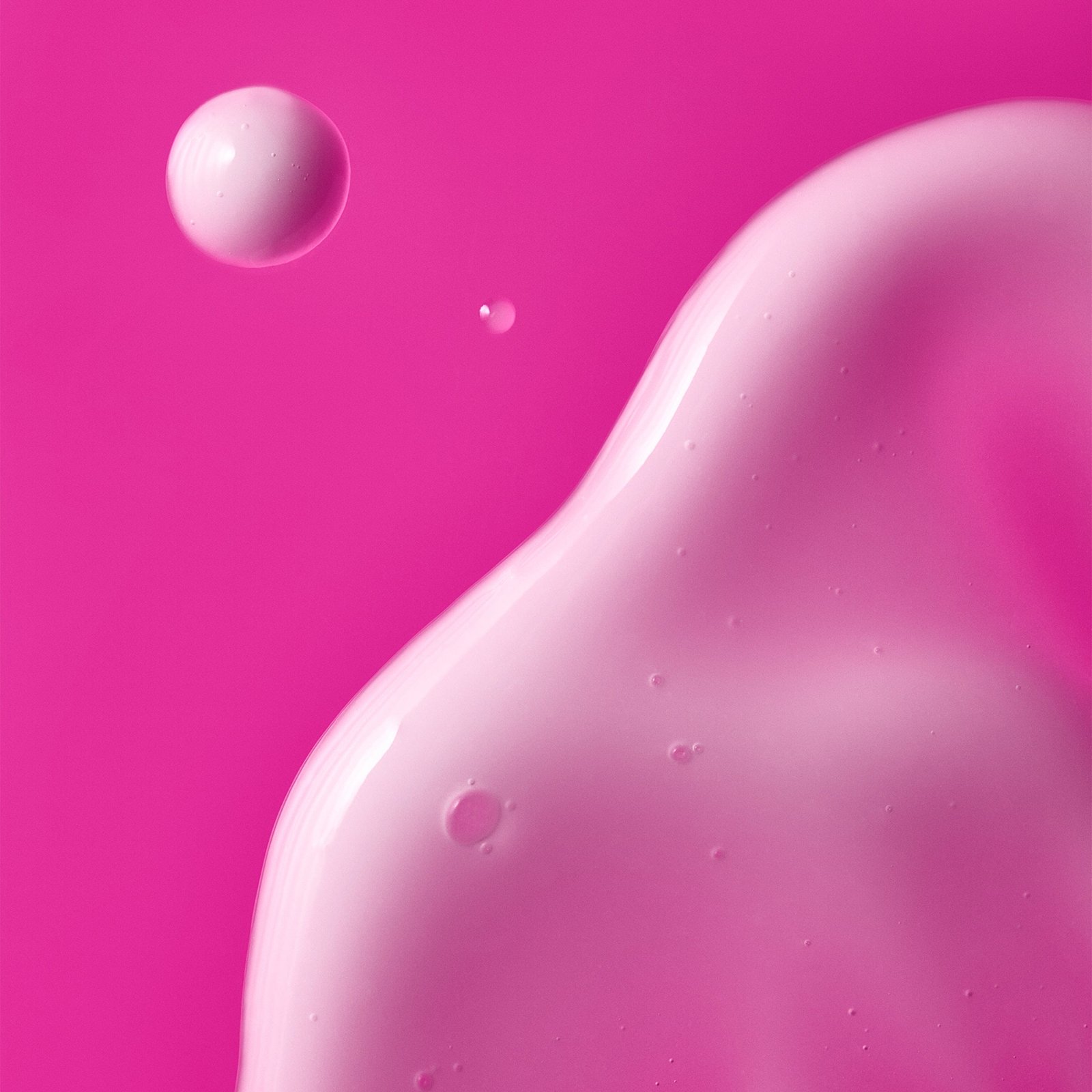 A close-up of a pink gel texture with suspended droplets.