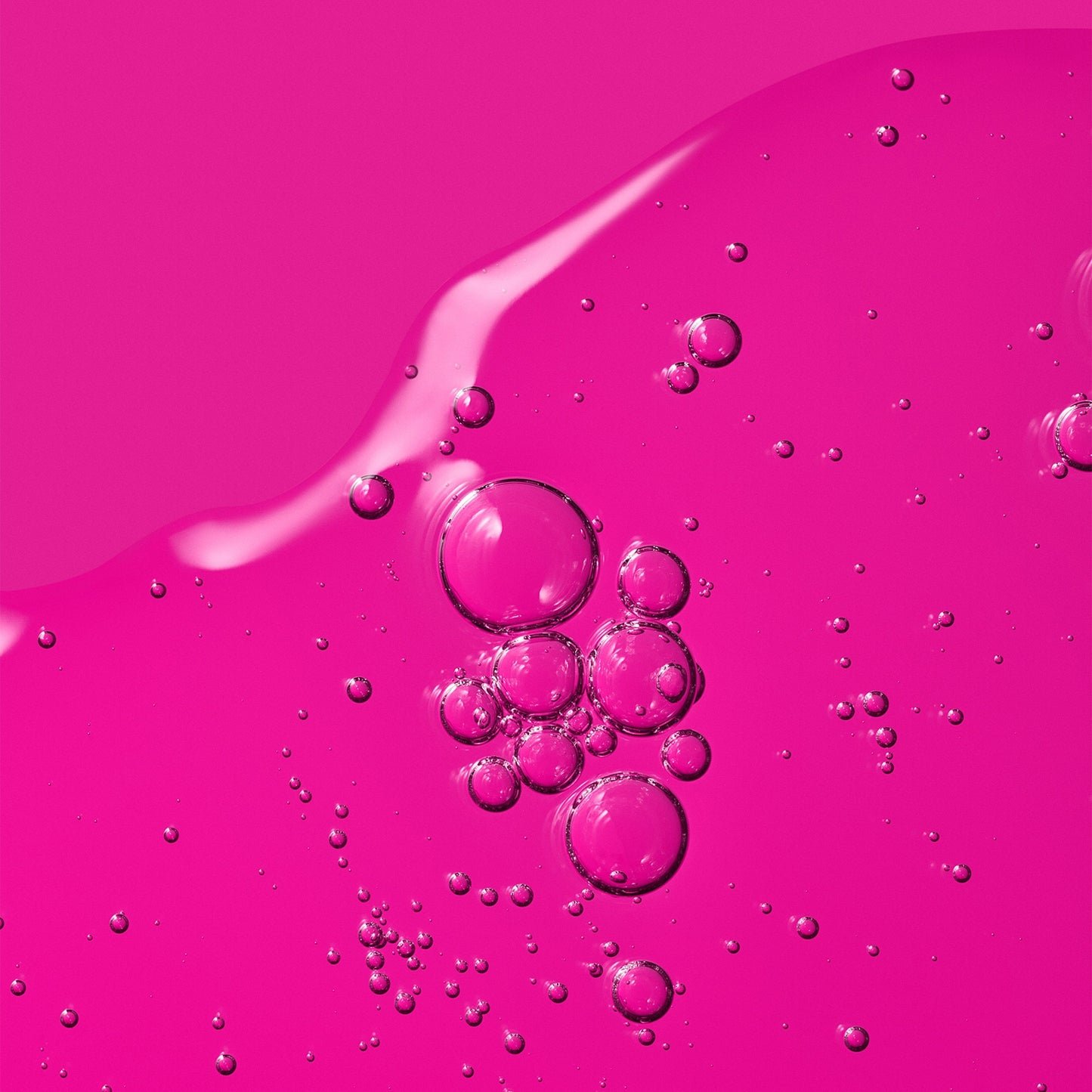 A vibrant pink gel texture with suspended air bubbles.