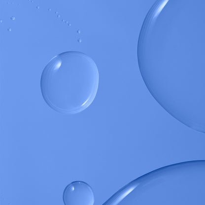 Clear, round skincare serum droplets of varying sizes scattered across a blue background. 