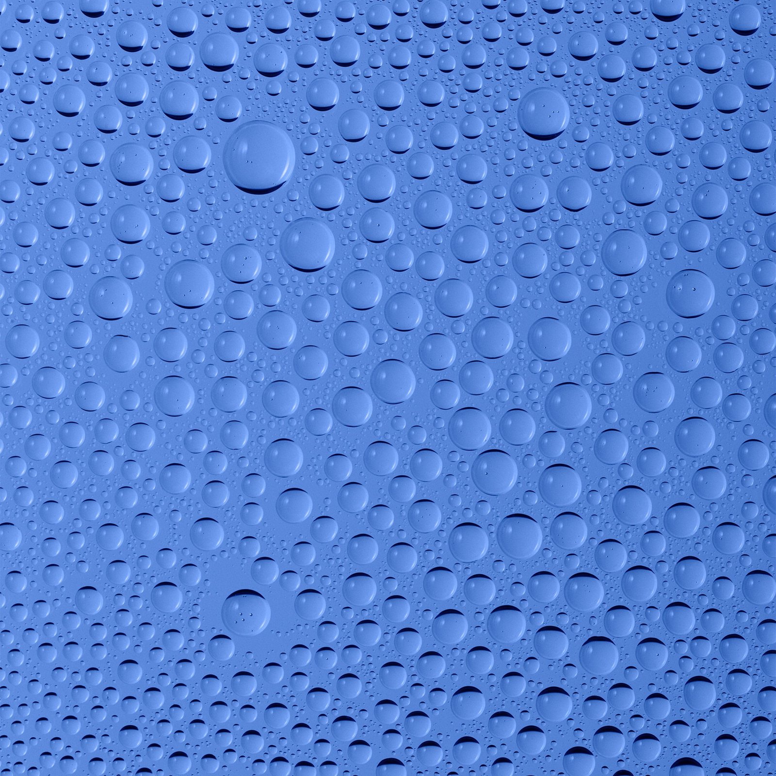 Water droplets on a smooth blue surface.
