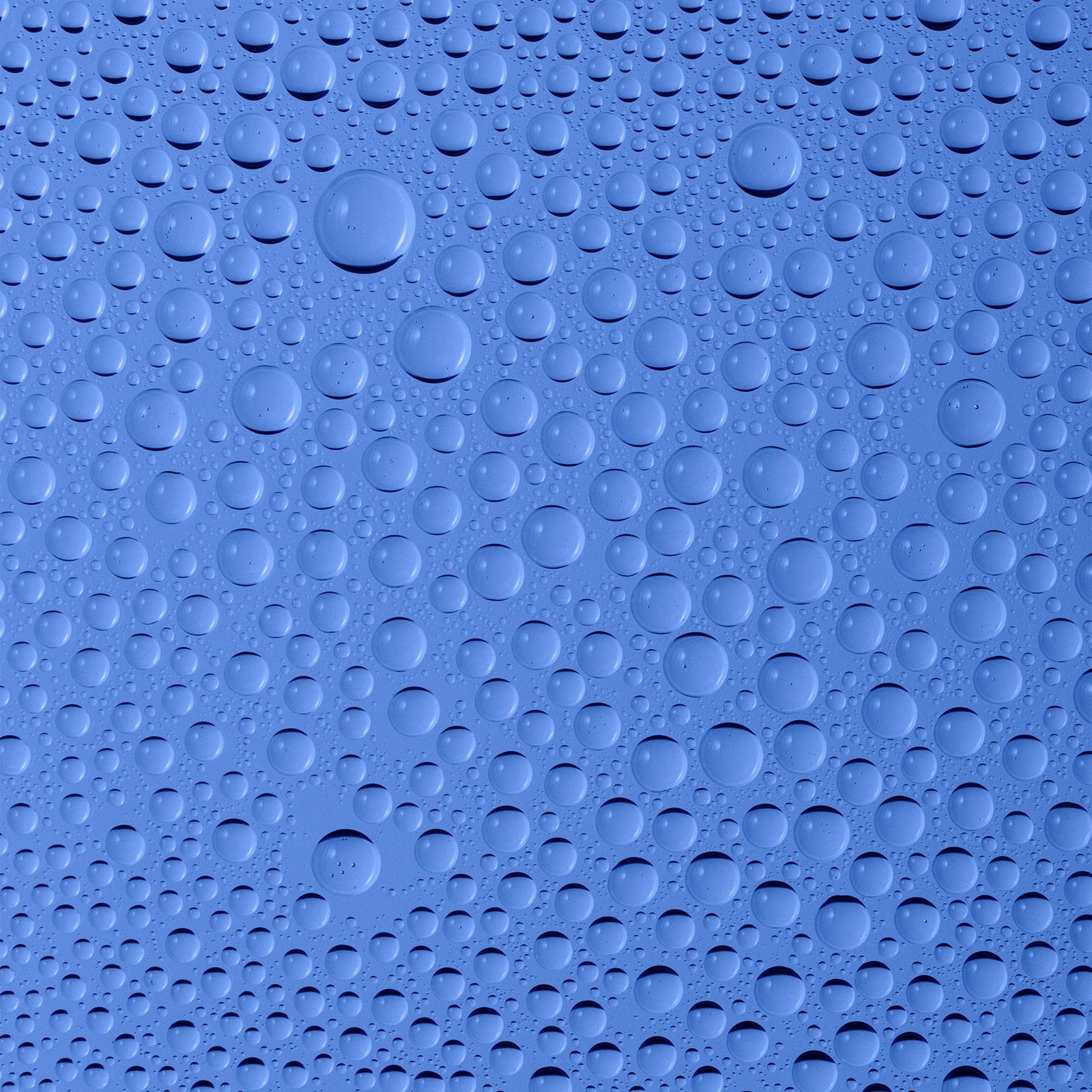 Water droplets on a smooth blue surface.