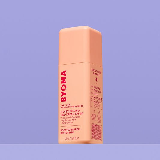 A peach-colored bottle of Byoma Moisturizing Gel-Cream SPF 30 with UVA/UVB protection.