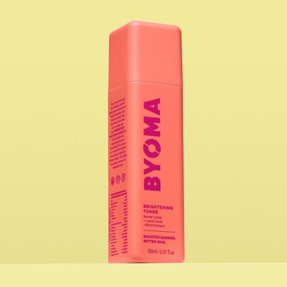 A BYOMA Brightening Toner bottle in a vibrant coral color. 