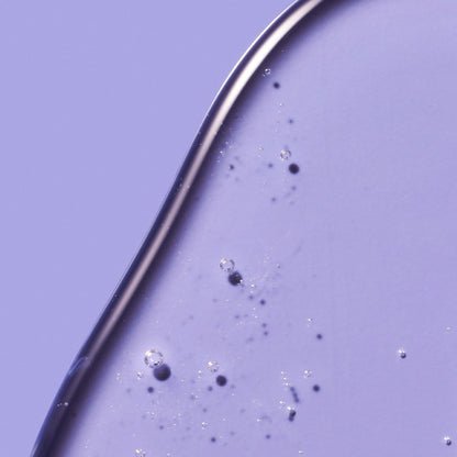 A clear, gel-like skincare product with tiny air bubbles.