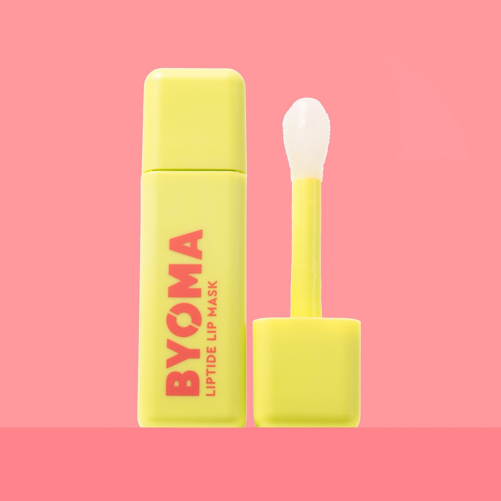 BYOMA Liptide Lip Mask in a vibrant yellow bottle. 