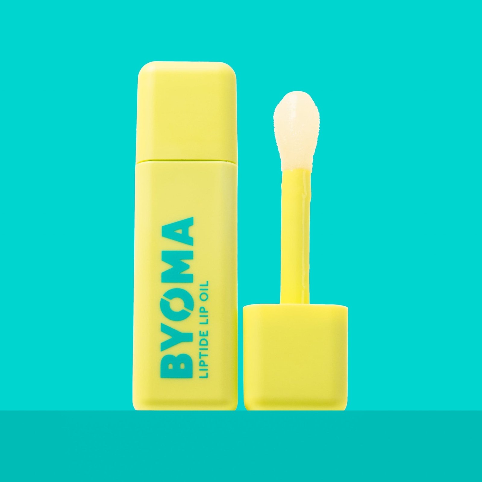 A BYOMA Liptide Lip Oil bottle with its applicator wand removed.