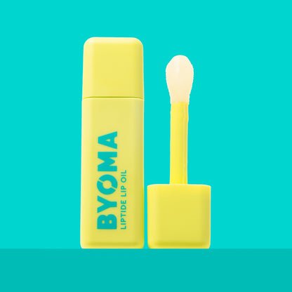 A BYOMA Liptide Lip Oil bottle with its applicator wand removed.