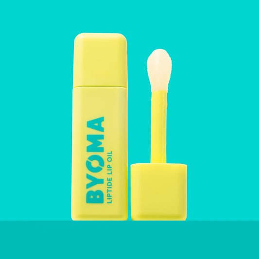 A BYOMA Liptide Lip Oil bottle with its applicator wand removed.