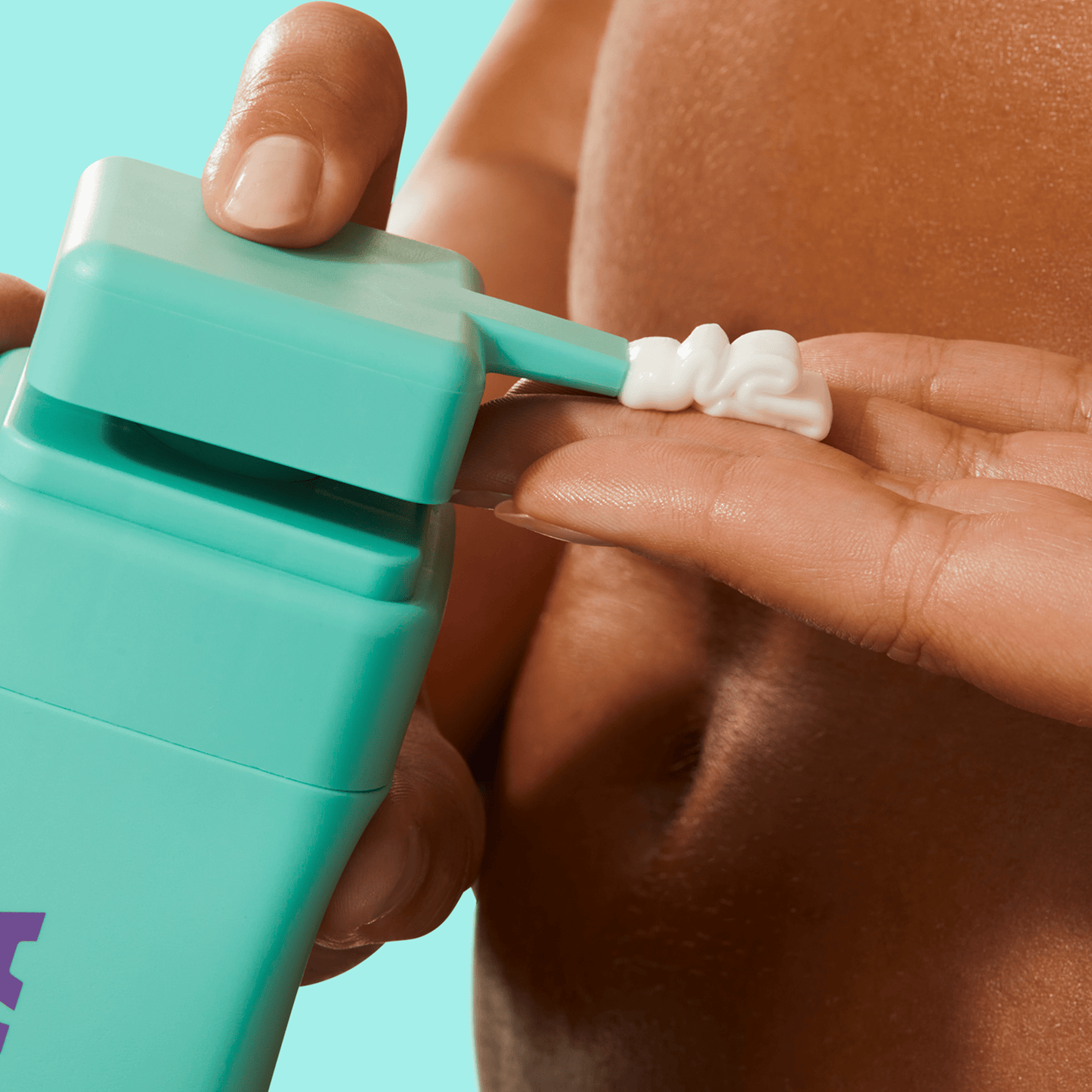 Byoma body lotion dispensed from a teal bottle onto fingers.
