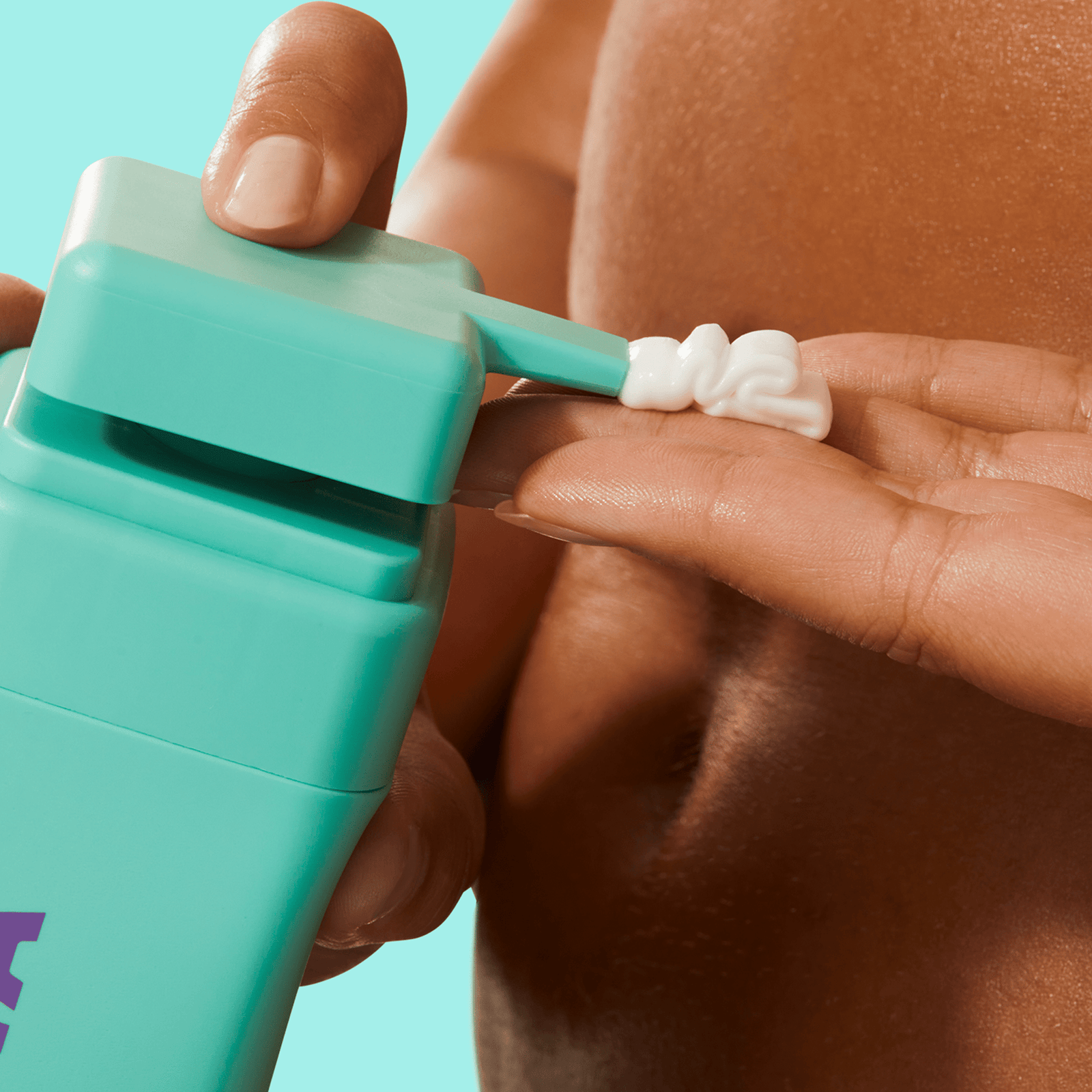 Byoma body lotion dispensed from a teal bottle onto fingers.