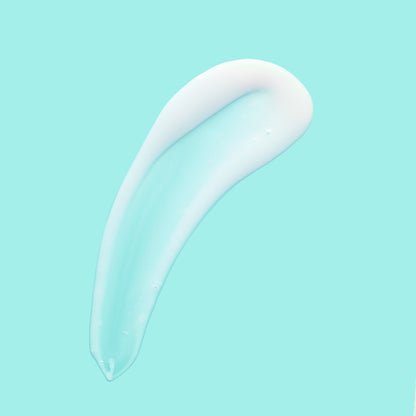 A creamy white skincare product smeared against a teal background.