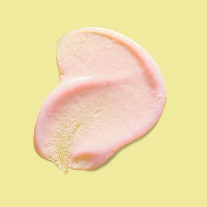 A textured swatch of pink exfoliating skincare product.