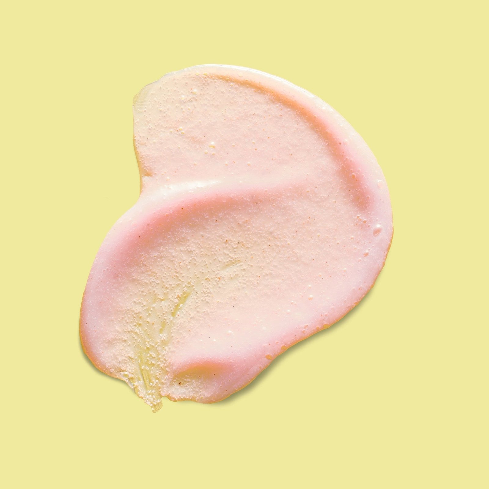 A textured swatch of pink exfoliating skincare product.