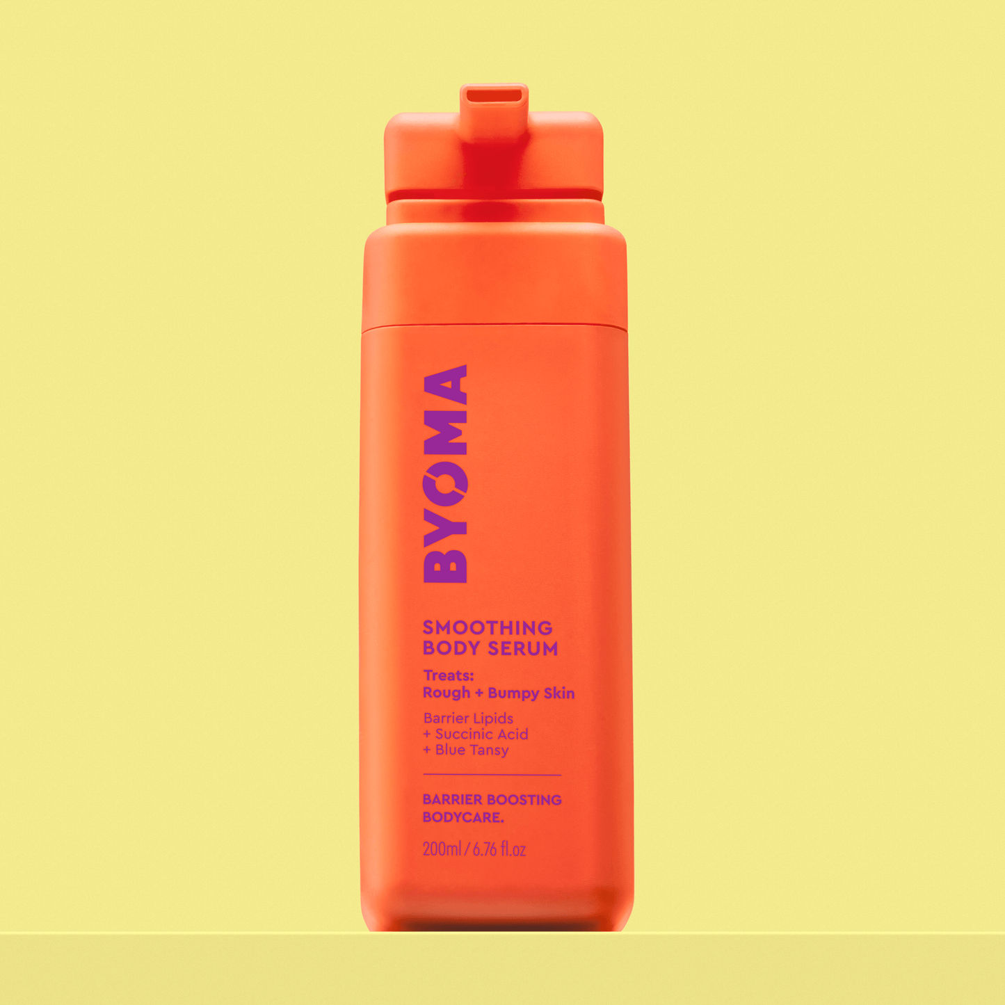 BYOMA Smoothing Body Serum in a bright orange bottle.