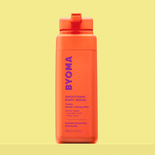 BYOMA Smoothing Body Serum in a bright orange bottle.
