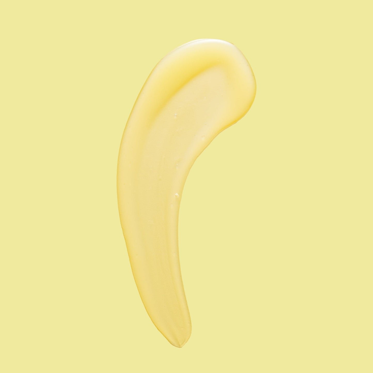 A smooth, skincare product swirled across a soft yellow background.