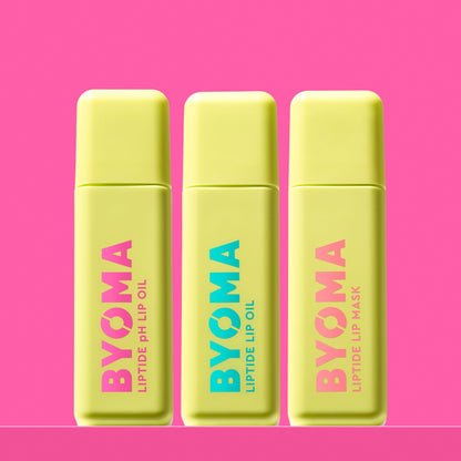 Three BYOMA Liptide lip treatments – pH Lip Oil, Lip Oil, and Lip Mask in yellow tubes against pink background