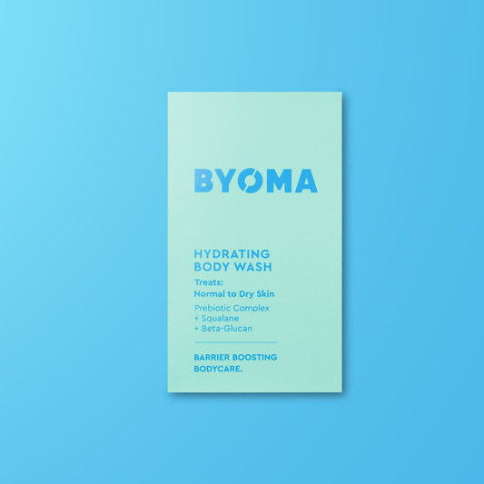 BYOMA hydrating body wash sample on a blue background