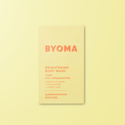 BYOMA brightening body wash sample on a light yellow background